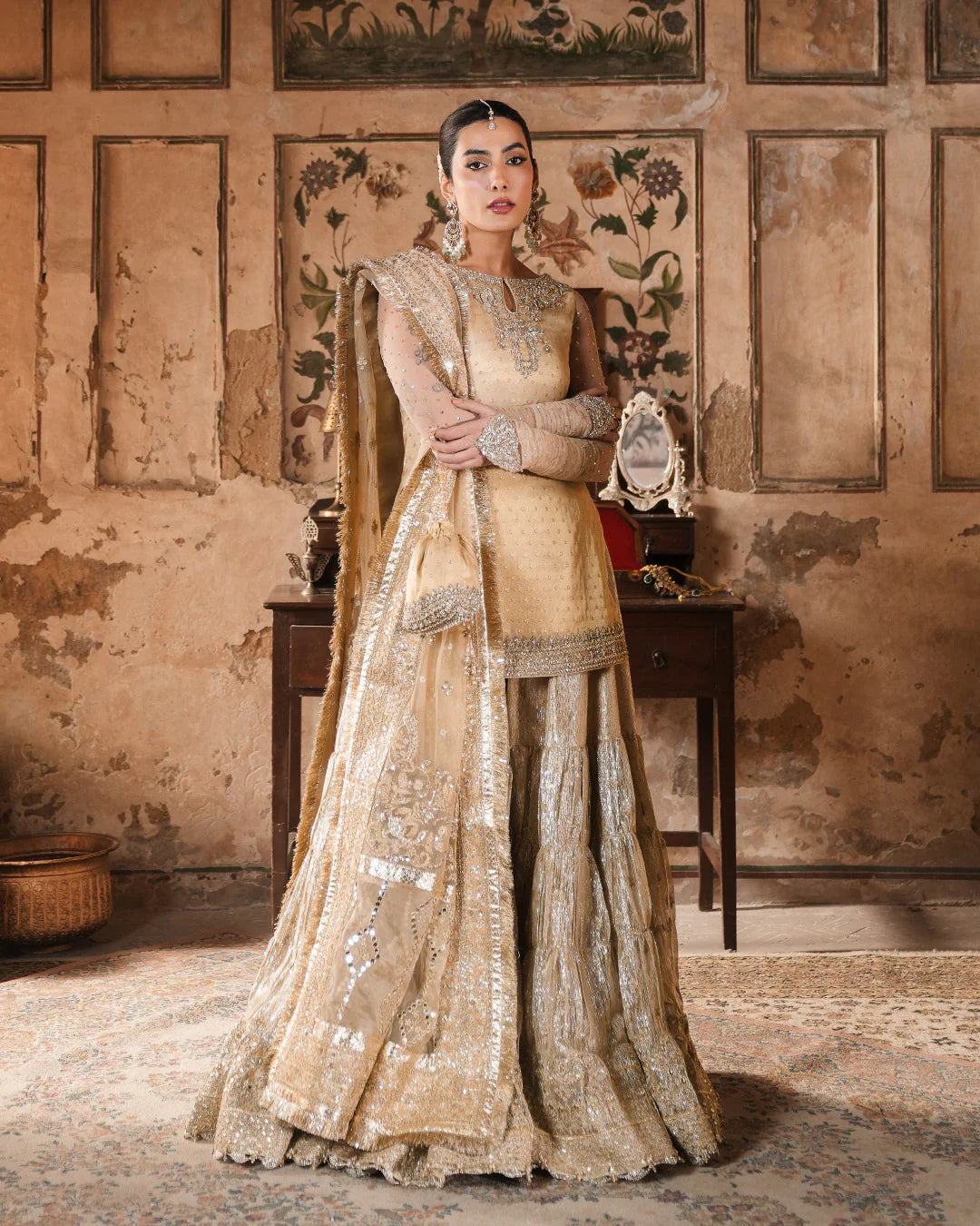 Model wearing gold Faiza Saqlain Camillie outfit with heavy embellishment, perfect for Pakistani luxury pret and festive wear in the UK.