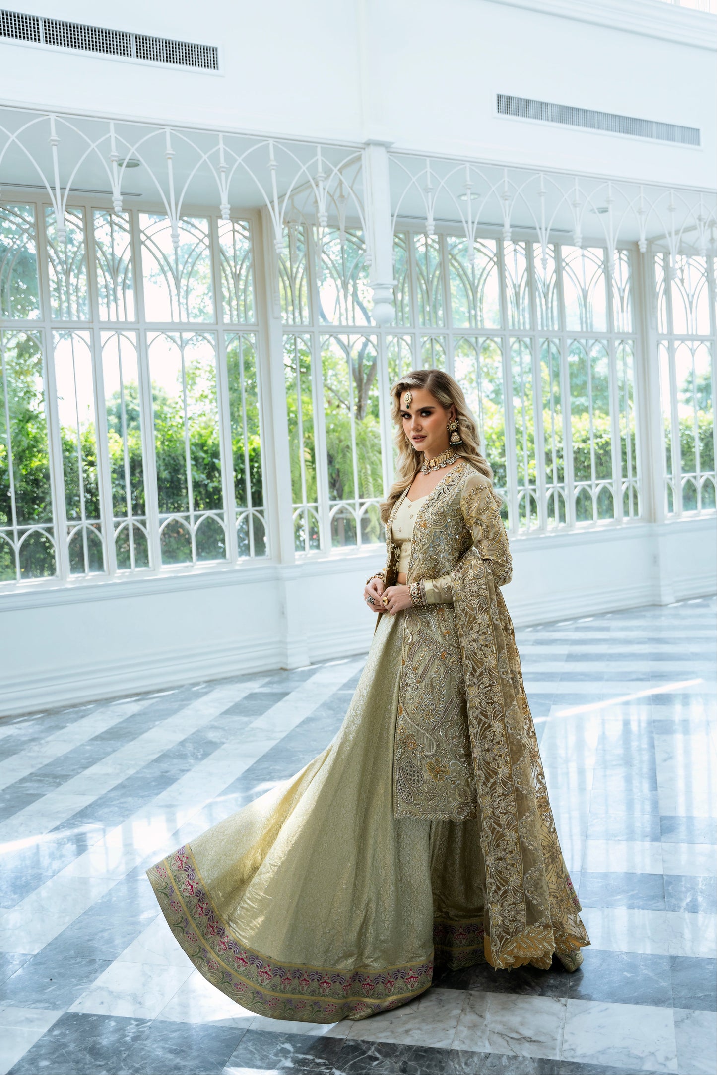 Model wearing Marigold from Mysie by Tahira, a golden-hued ensemble with intricate embroidery, ideal for Pakistani luxury pret in the UK.