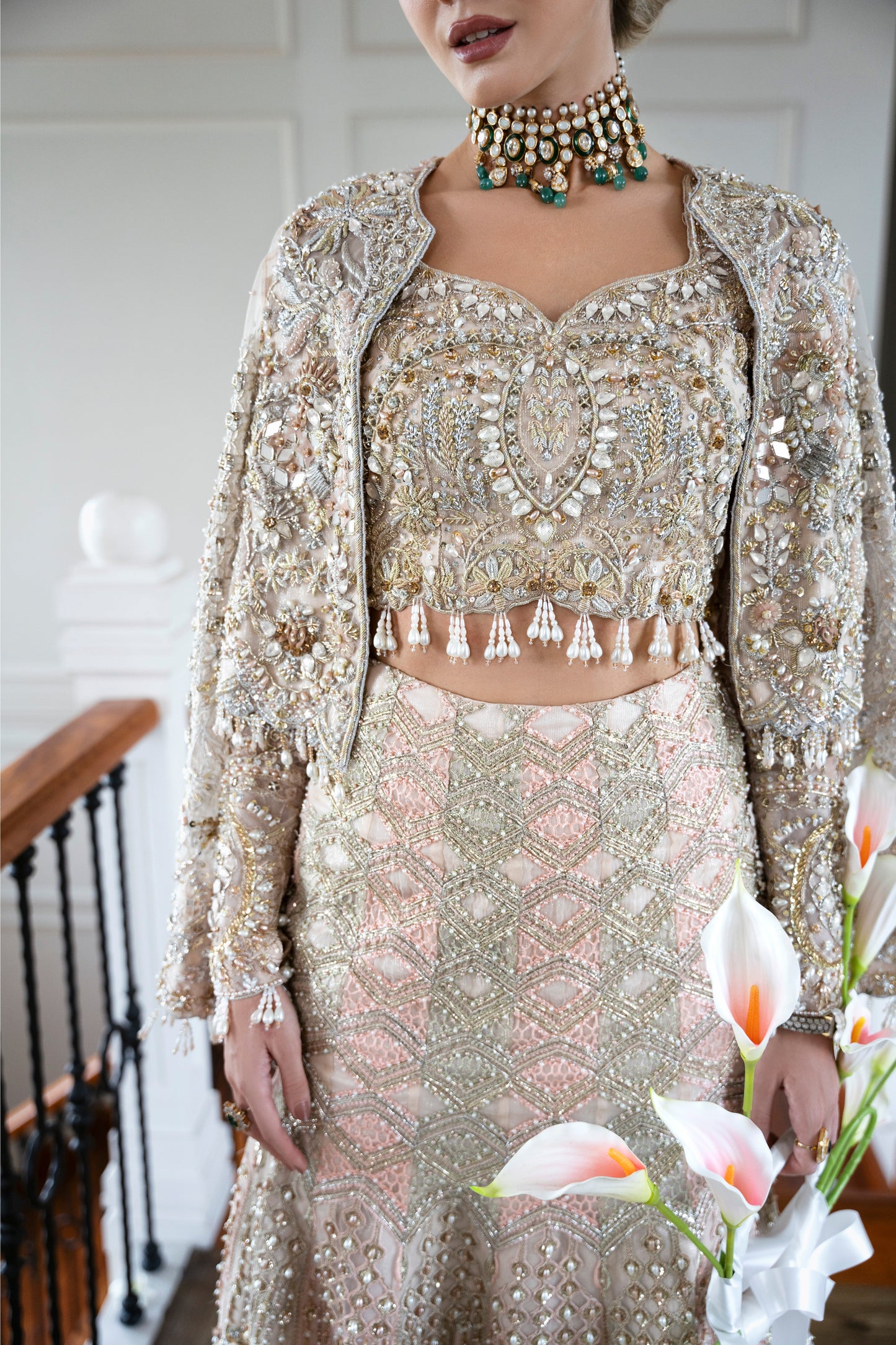 Model wearing soft pastel pink and gold embellished lehenga MALISA from Mysie by Tahira, Pakistani luxury pret available online in UK.
