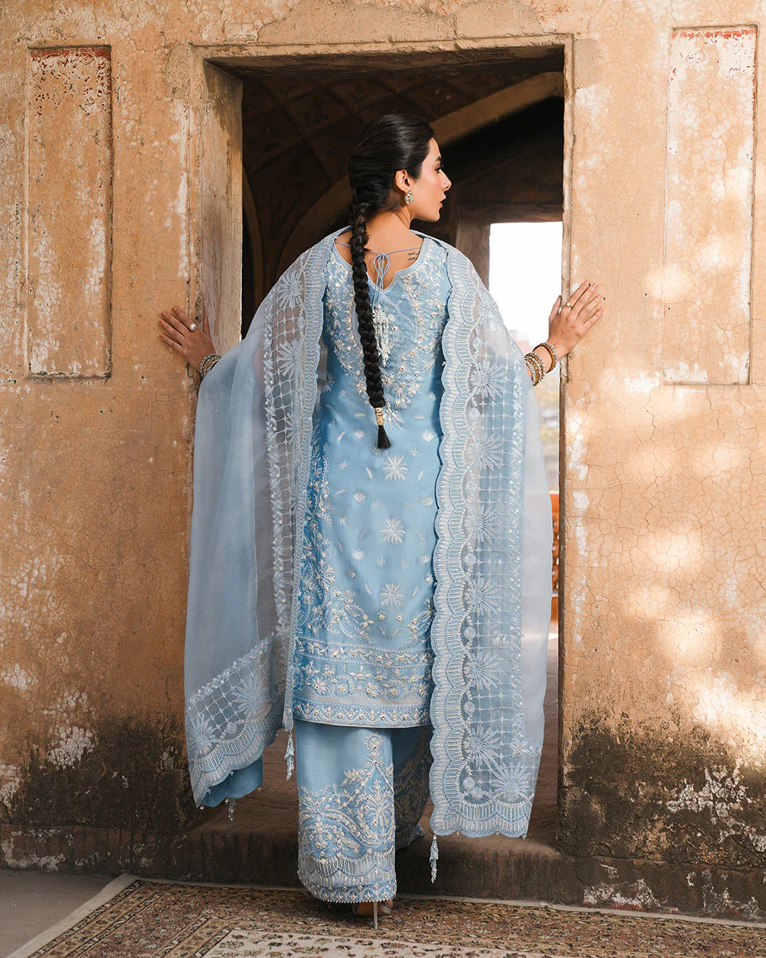 Model wearing powder blue Faiza Saqlain Yulia outfit with intricate embroidery and scalloped dupatta, ideal for Pakistani luxury pret in UK.