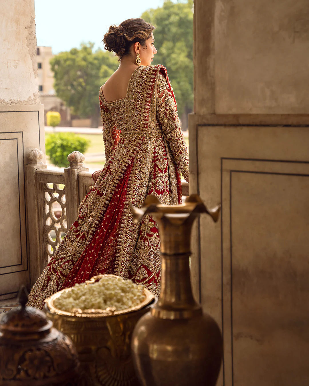 Model wearing deep red and gold bridal dress Juri by Faiza Saqlain, Pakistani luxury pret online in UK for weddings.