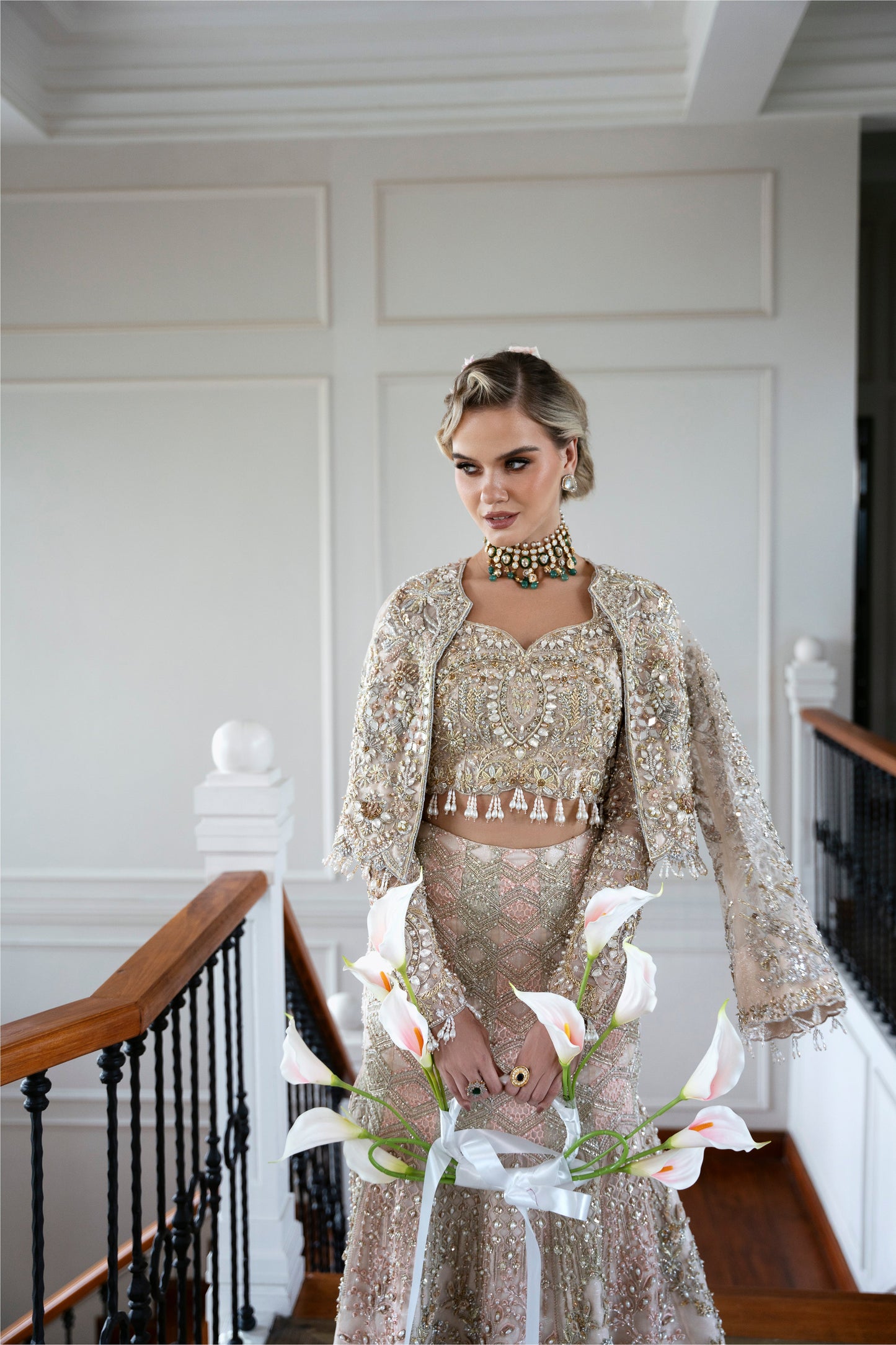 Model wearing soft pastel pink and gold embellished lehenga MALISA from Mysie by Tahira, Pakistani luxury pret available online in UK.