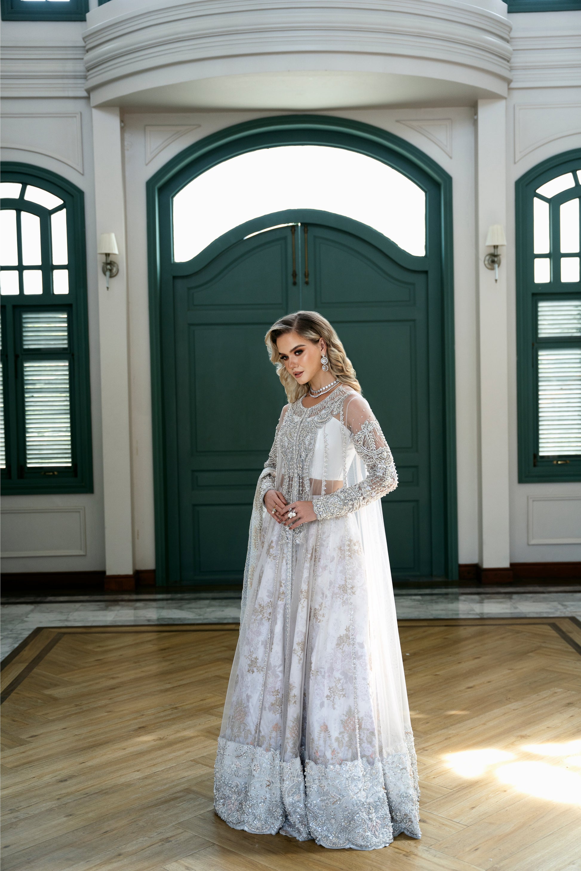 Model wearing Snowdrop from Mysie by Tahira, a stunning white and silver luxury pret outfit, perfect for Pakistani clothes in the UK.