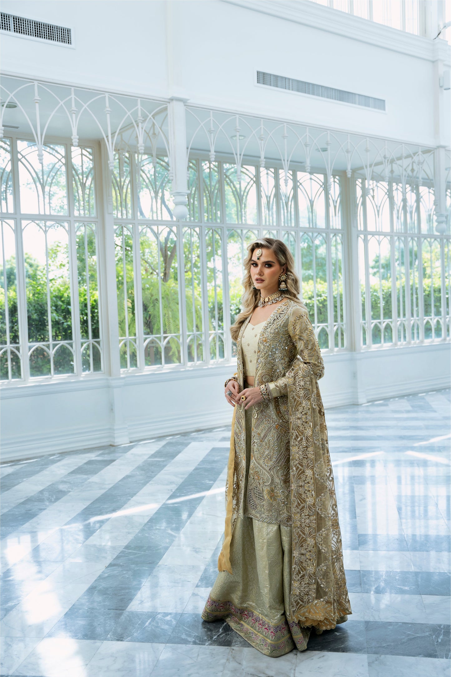 Model wearing Marigold from Mysie by Tahira, a golden-hued ensemble with intricate embroidery, ideal for Pakistani luxury pret in the UK.