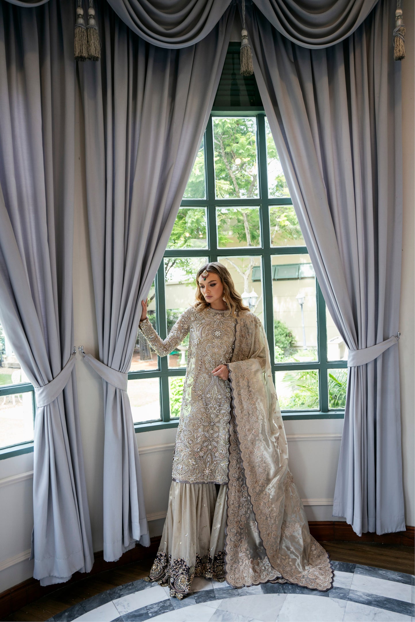 Model wearing Arya from Mysie by Tahira in beige with intricate embellishments, perfect for Pakistani luxury pret in the UK.