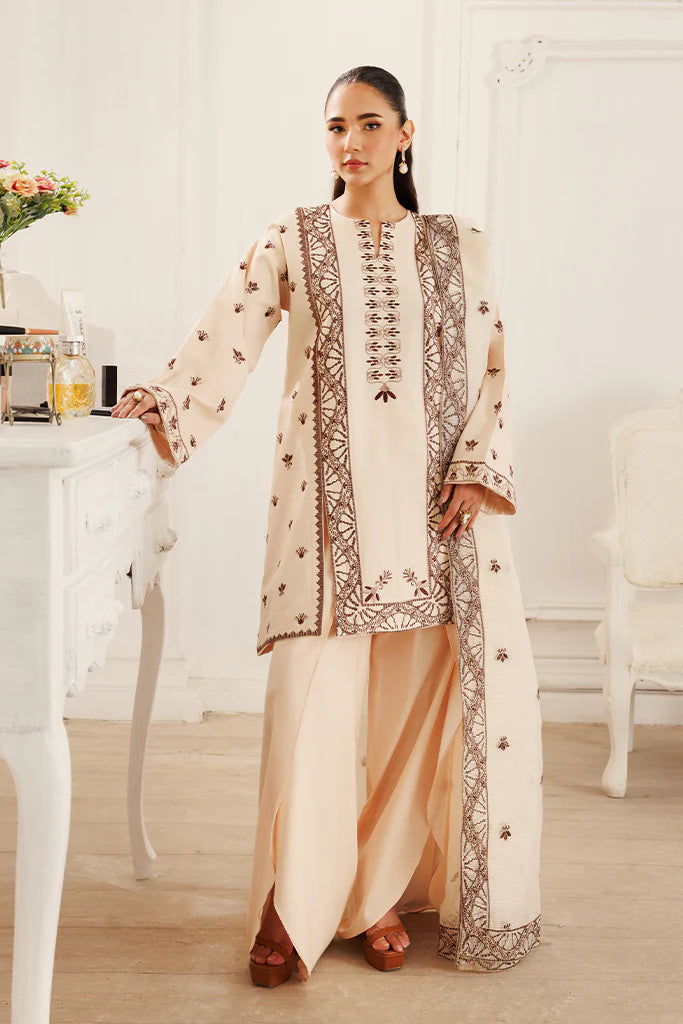Model wearing Dusky Dreams by Saffron in beige with intricate embroidery – Pakistani luxury pret outfit online in UK.