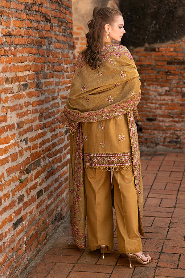 Model wearing mustard yellow embroidered dress from Saffron Winter Edit Aurora, Pakistani luxury pret available online in UK.