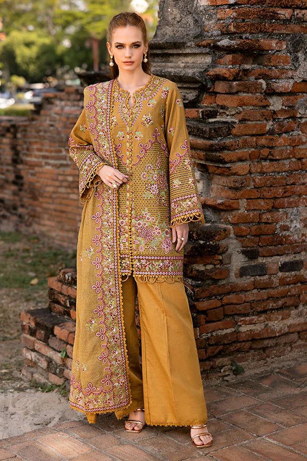 Model wearing mustard yellow embroidered dress from Saffron Winter Edit Aurora, Pakistani luxury pret available online in UK.