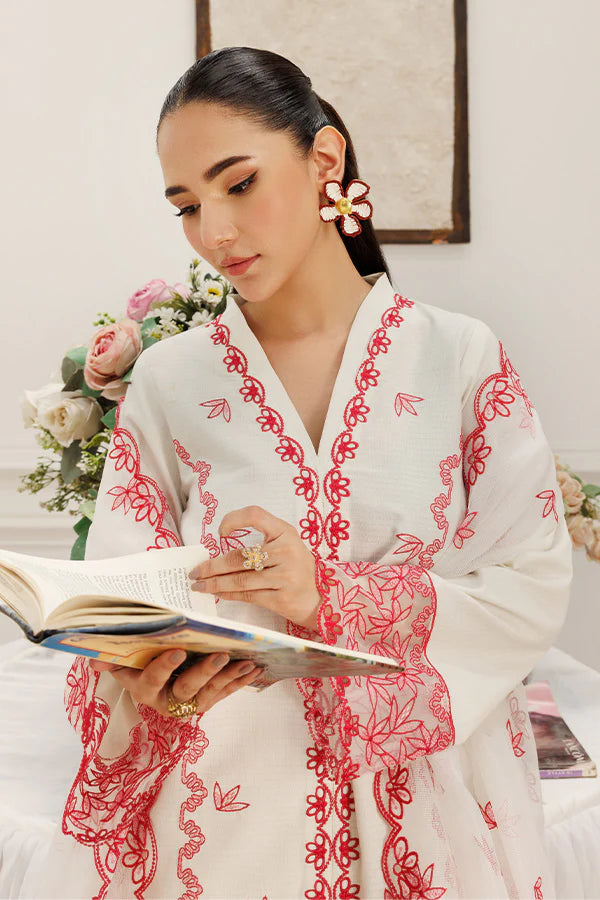Model wearing Dewtide by Saffron in white with red floral embroidery – elegant Pakistani luxury pret outfit available online in UK.