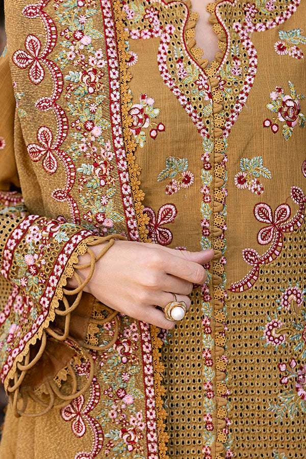 Model wearing mustard yellow embroidered dress from Saffron Winter Edit Aurora, Pakistani luxury pret available online in UK.