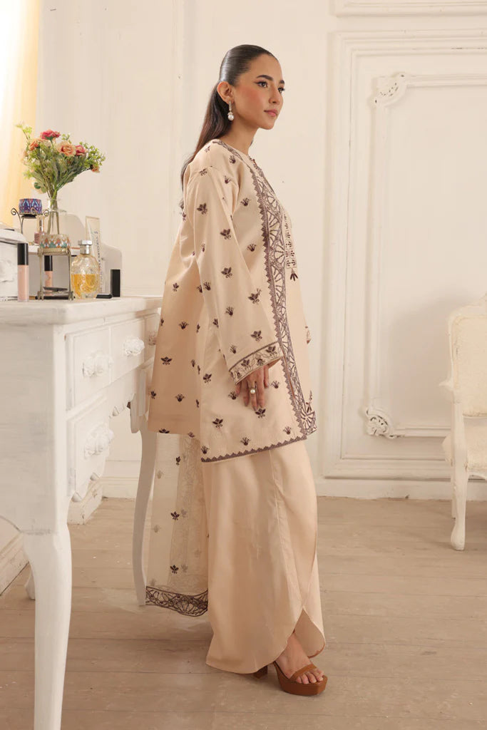 Model wearing Dusky Dreams by Saffron in beige with intricate embroidery – Pakistani luxury pret outfit online in UK.