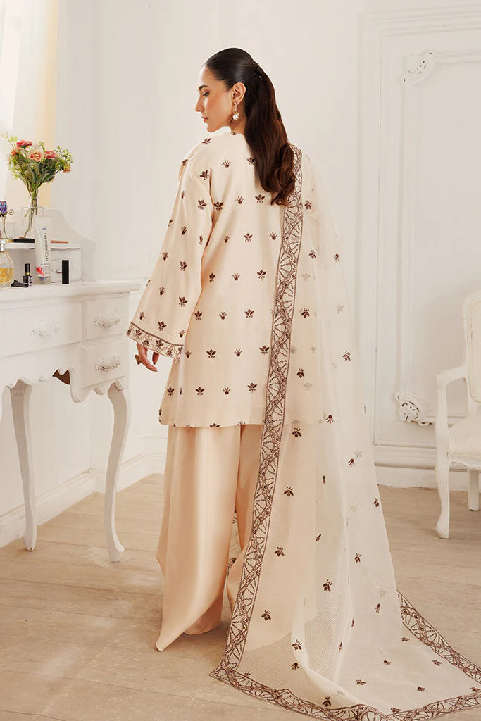 Model wearing Dusky Dreams by Saffron in beige with intricate embroidery – Pakistani luxury pret outfit online in UK.