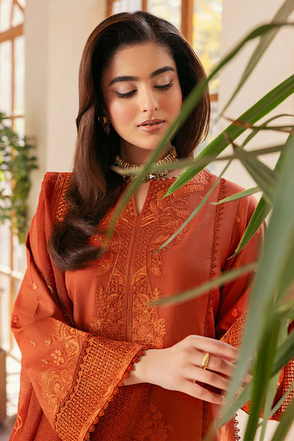 Model wearing rust orange embroidered dress from Saffron Summer Soiree '25 Delilah, Pakistani luxury pret available online in UK.