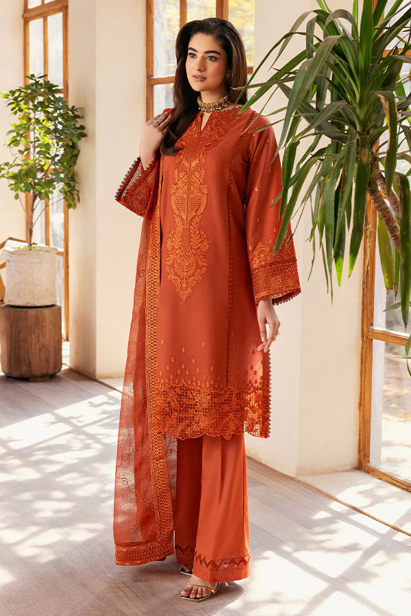 Model wearing rust orange embroidered dress from Saffron Summer Soiree '25 Delilah, Pakistani luxury pret available online in UK.