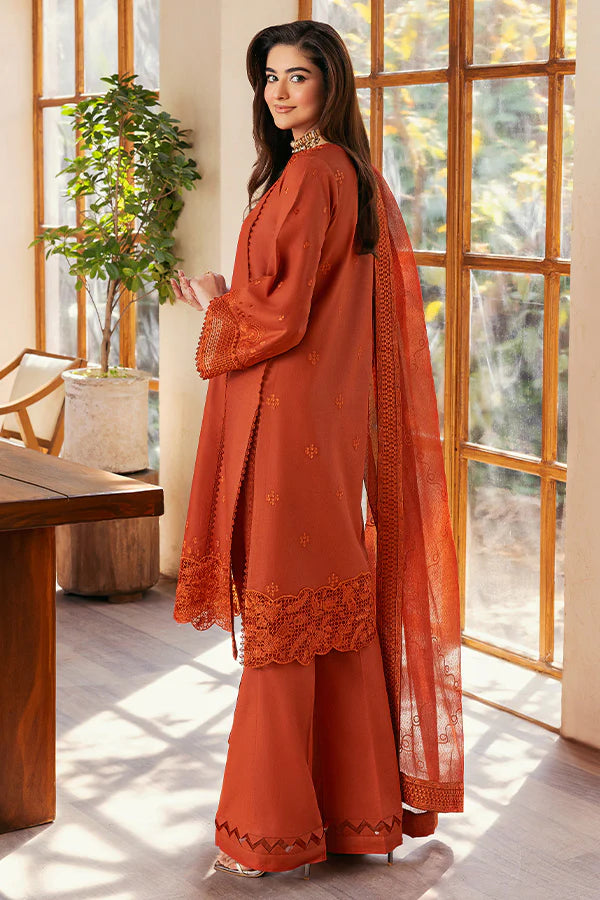 Model wearing rust orange embroidered dress from Saffron Summer Soiree '25 Delilah, Pakistani luxury pret available online in UK.