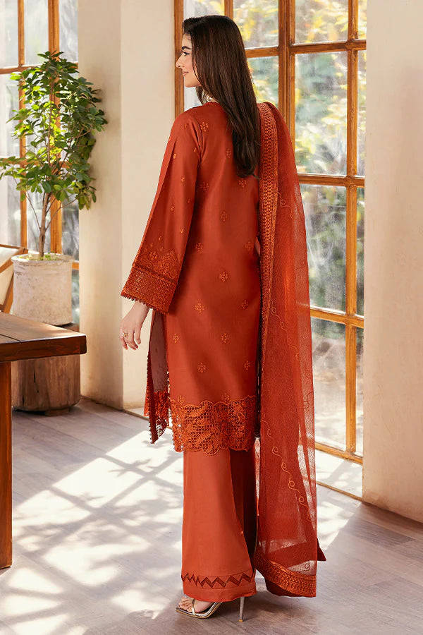 Model wearing rust orange embroidered dress from Saffron Summer Soiree '25 Delilah, Pakistani luxury pret available online in UK.