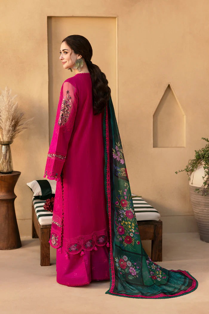 Model wearing hot pink embroidered three-piece suit with dark green printed dupatta from Saira Rizwan, Pakistani luxury pret, Pakistani clothes online in UK.