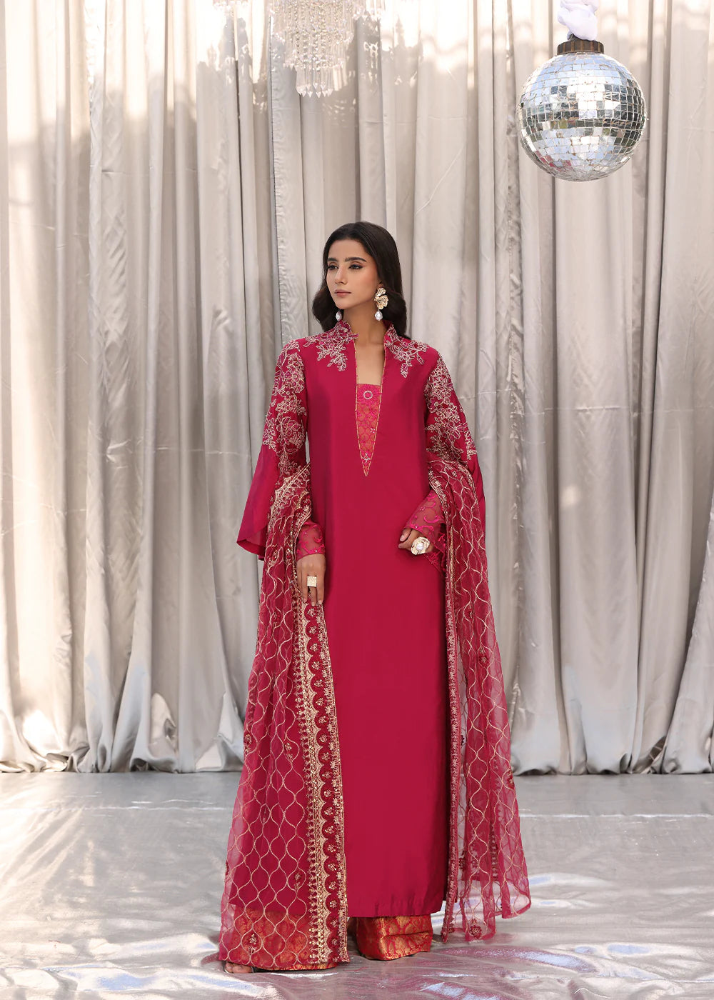 Model wearing cherry red embroidered dress with net dupatta from Musferah Saad Cherry Wine, Pakistani Luxury pret available online in UK.