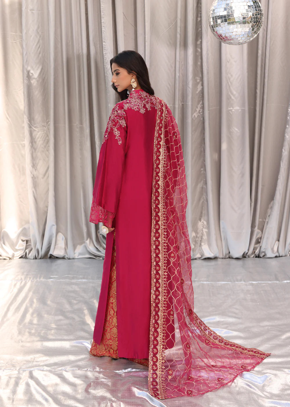Model wearing cherry red embroidered dress with net dupatta from Musferah Saad Cherry Wine, Pakistani Luxury pret available online in UK.