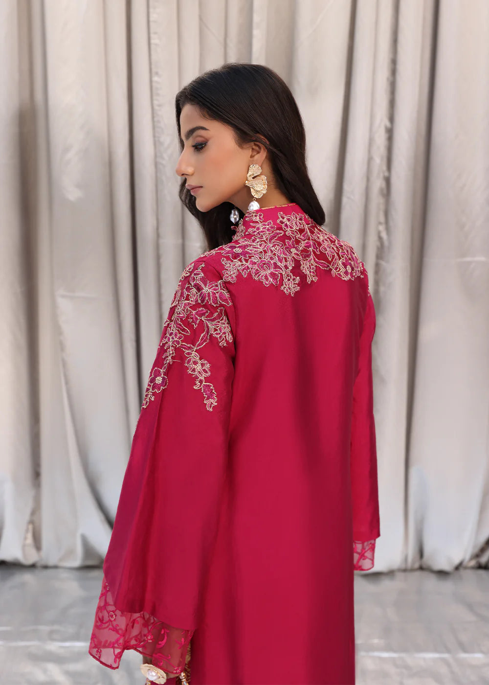 Model wearing cherry red embroidered dress with net dupatta from Musferah Saad Cherry Wine, Pakistani Luxury pret available online in UK.