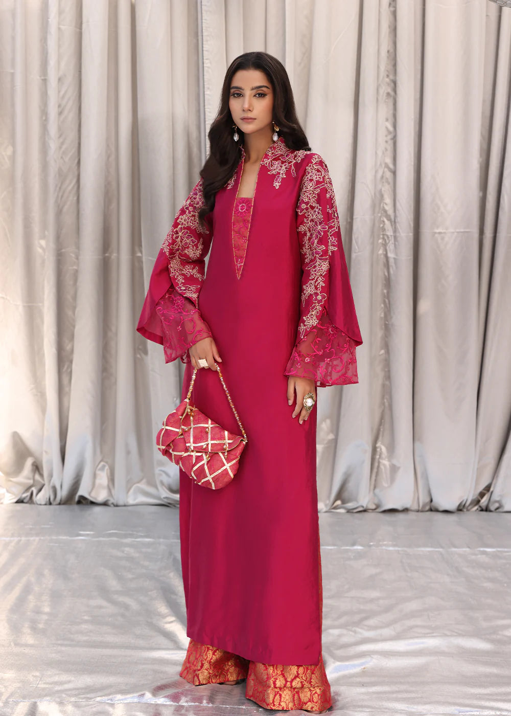 Model wearing cherry red embroidered dress with net dupatta from Musferah Saad Cherry Wine, Pakistani Luxury pret available online in UK.
