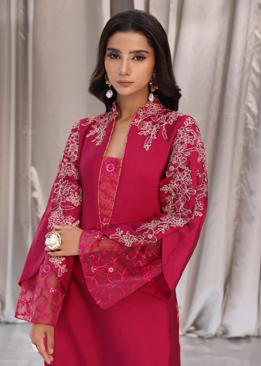 Model wearing cherry red embroidered dress with net dupatta from Musferah Saad Cherry Wine, Pakistani Luxury pret available online in UK.