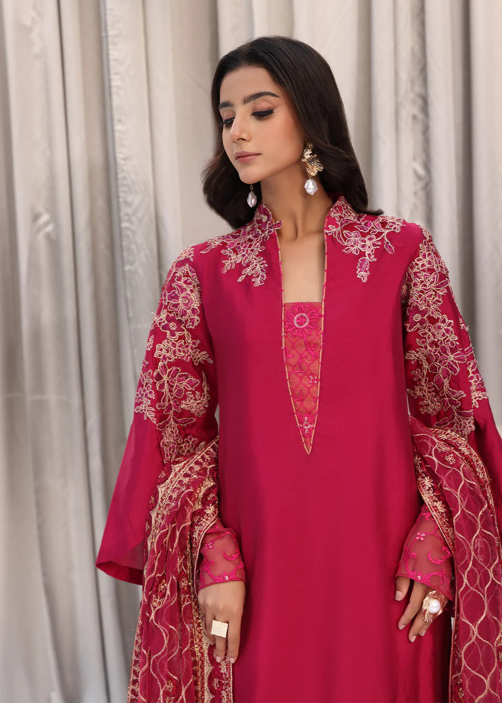 Model wearing cherry red embroidered dress with net dupatta from Musferah Saad Cherry Wine, Pakistani Luxury pret available online in UK.