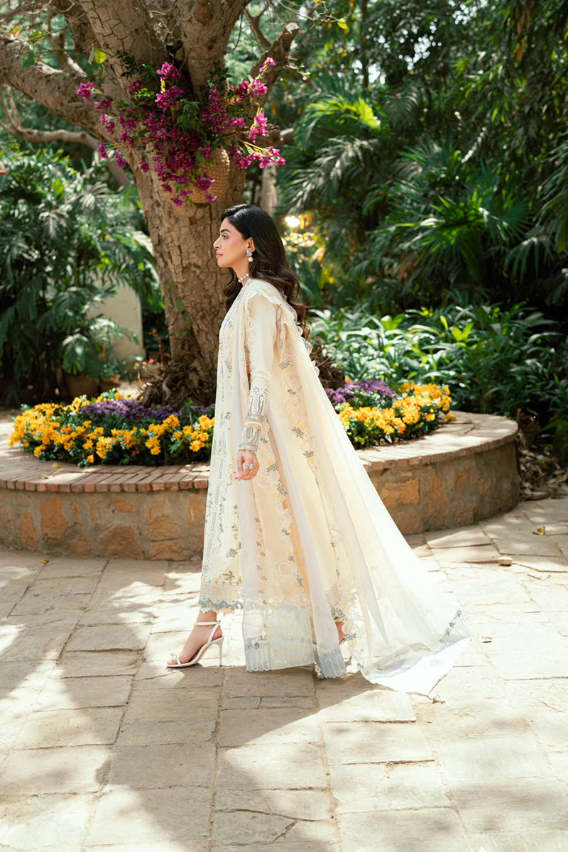 Model wearing ivory Qalamkar SB-09 Adeena embroidered outfit with sky blue accents, perfect for Eid and Pakistani luxury pret online in UK.