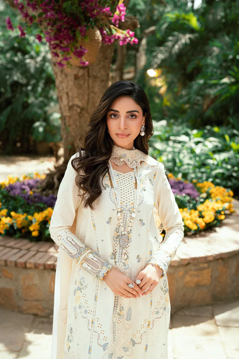 Model wearing ivory Qalamkar SB-09 Adeena embroidered outfit with sky blue accents, perfect for Eid and Pakistani luxury pret online in UK.