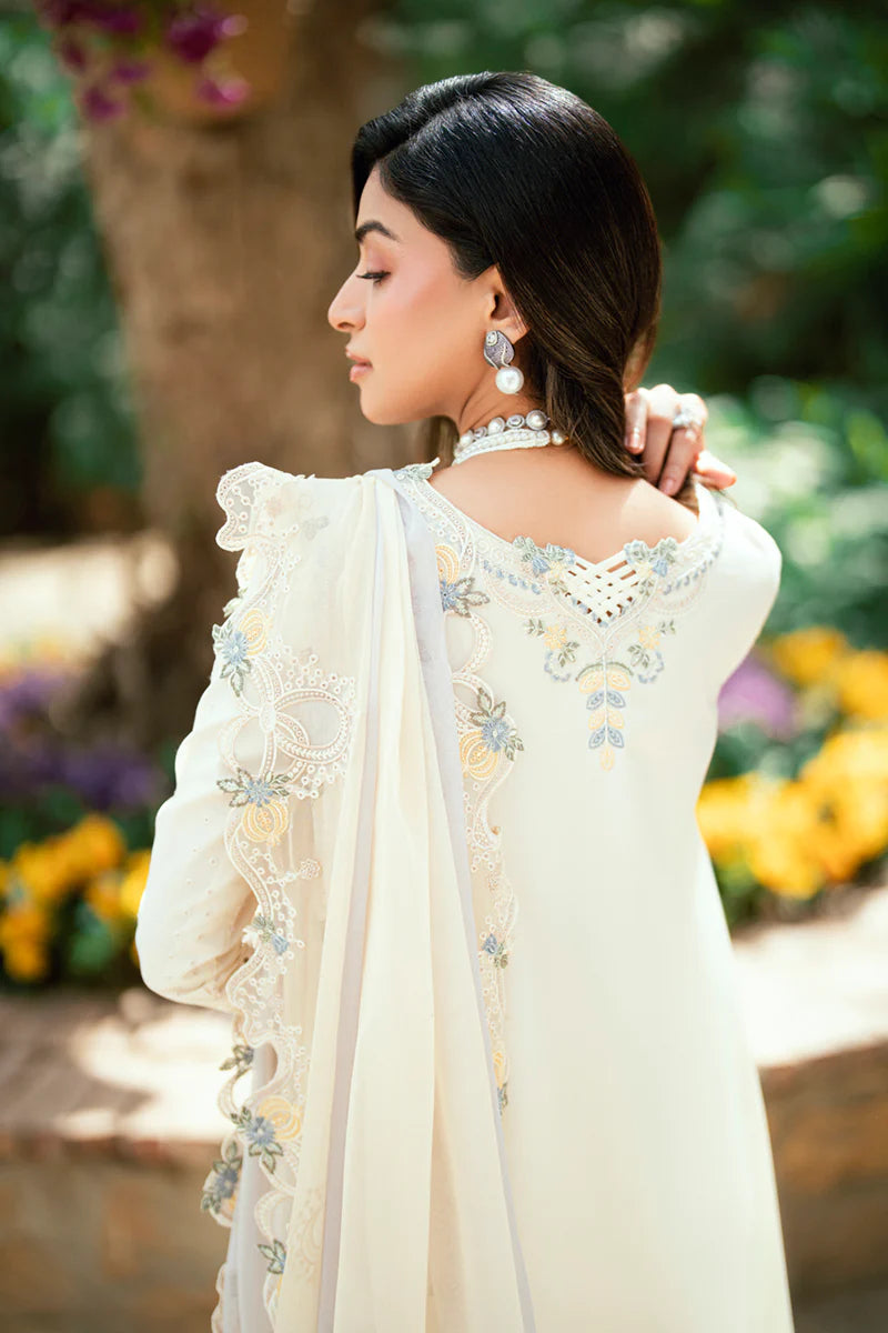 Model wearing ivory Qalamkar SB-09 Adeena embroidered outfit with sky blue accents, perfect for Eid and Pakistani luxury pret online in UK.