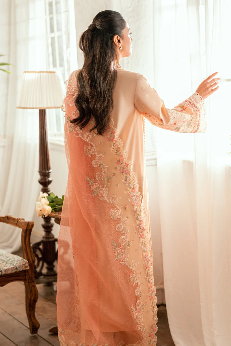 Model wearing peach Qalamkar SB-07 Zoya embroidered suit with floral detailing, perfect for Eid and Pakistani luxury pret online in UK.