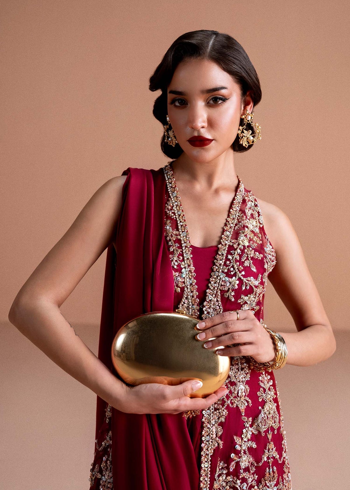Model wearing deep maroon Naura outfit from Kanwal Malik, featuring intricate embroidery for Pakistani luxury pret and clothes online in UK.
