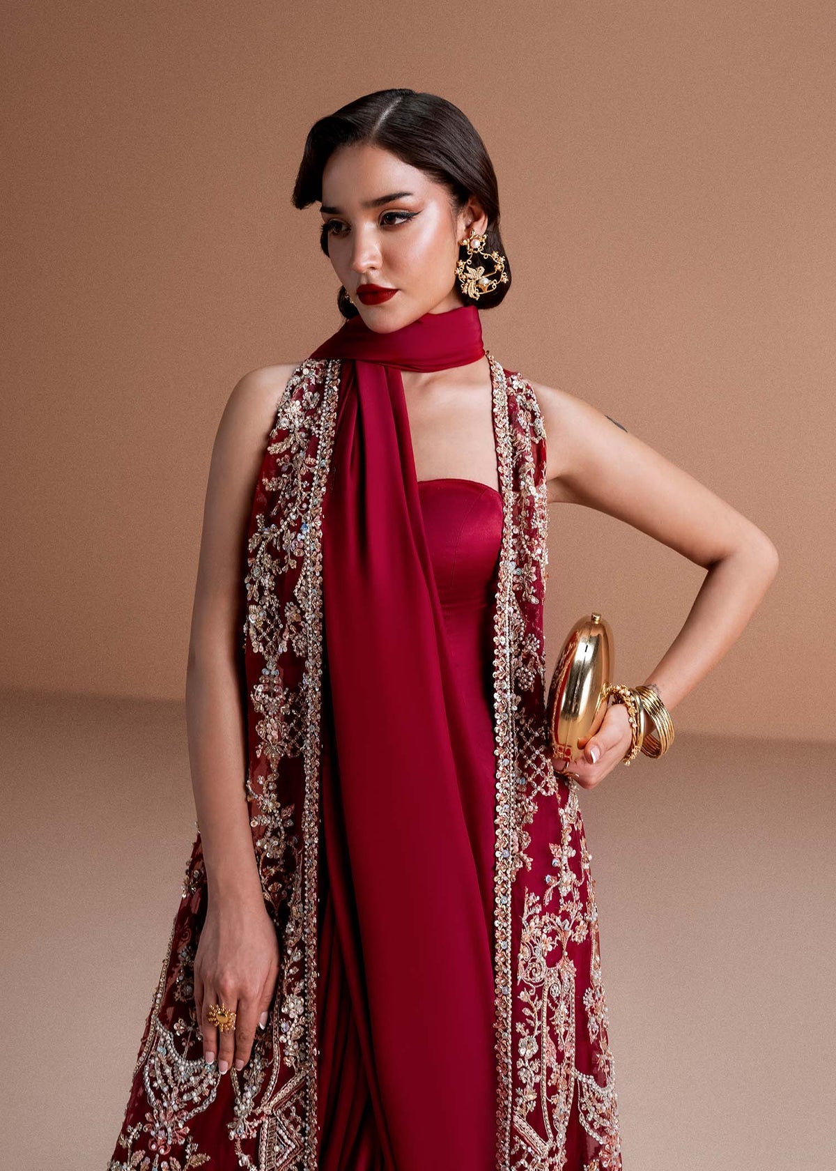 Model wearing deep maroon Naura outfit from Kanwal Malik, featuring intricate embroidery for Pakistani luxury pret and clothes online in UK.