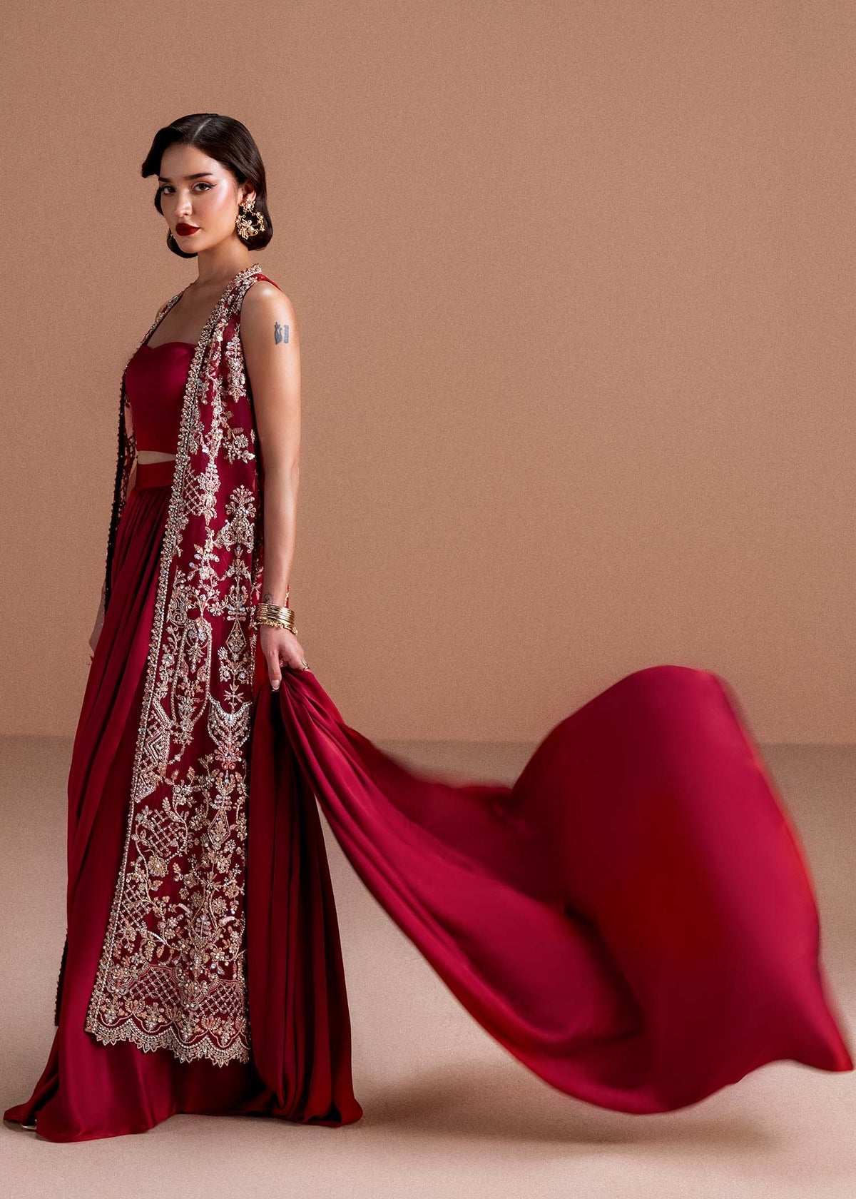 Model wearing deep maroon Naura outfit from Kanwal Malik, featuring intricate embroidery for Pakistani luxury pret and clothes online in UK.