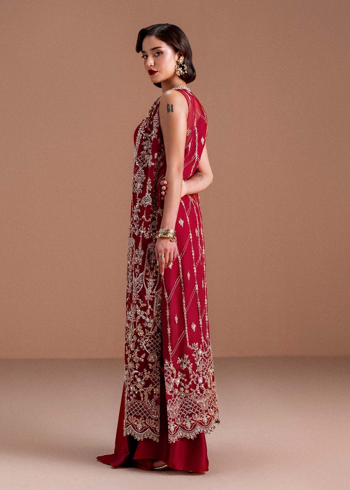 Model wearing deep maroon Naura outfit from Kanwal Malik, featuring intricate embroidery for Pakistani luxury pret and clothes online in UK.