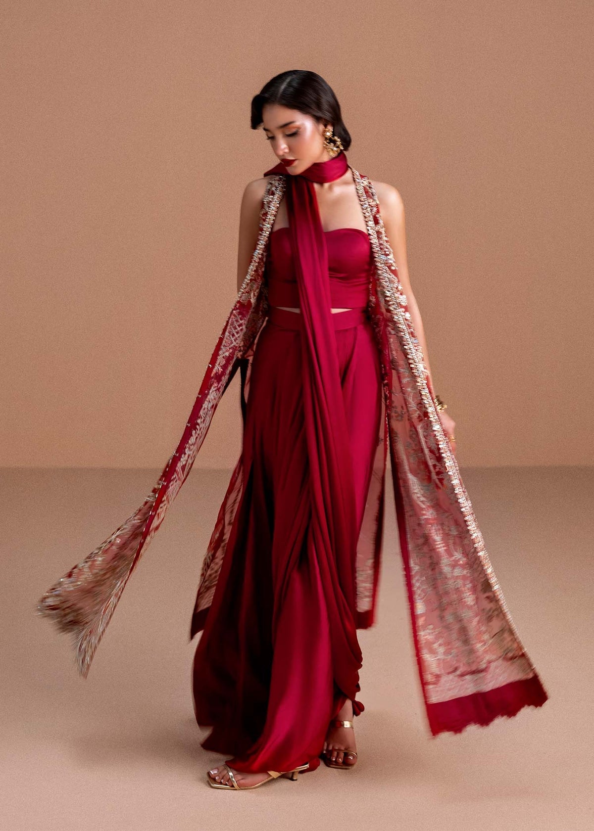 Model wearing deep maroon Naura outfit from Kanwal Malik, featuring intricate embroidery for Pakistani luxury pret and clothes online in UK.