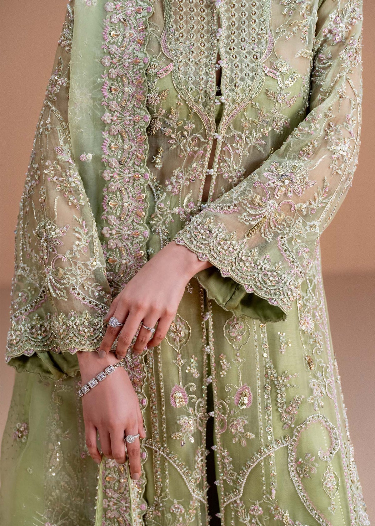 Model wearing pistachio green Sila outfit from Kanwal Malik, adorned with delicate embroidery for Pakistani luxury pret and clothes online in UK.