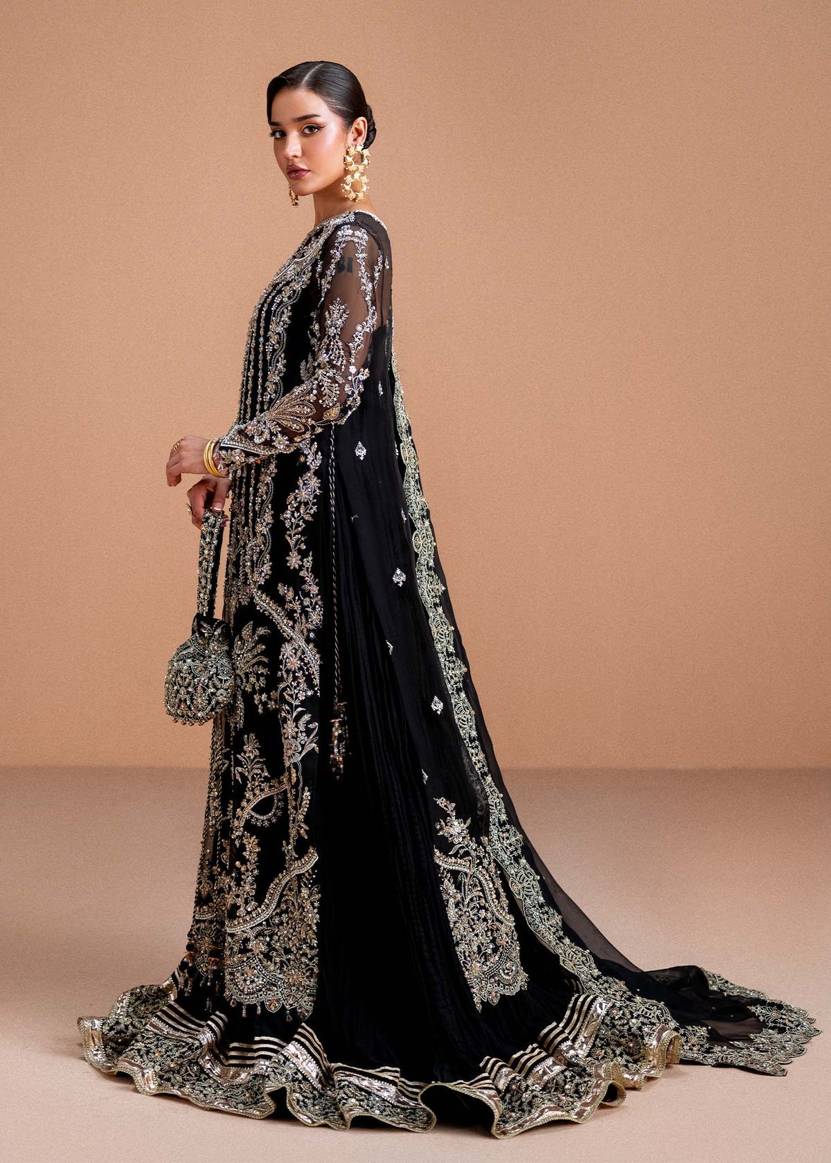 Model wearing black Rayen outfit from Kanwal Malik, showcasing intricate embroidery for Pakistani luxury pret and clothes online in UK.