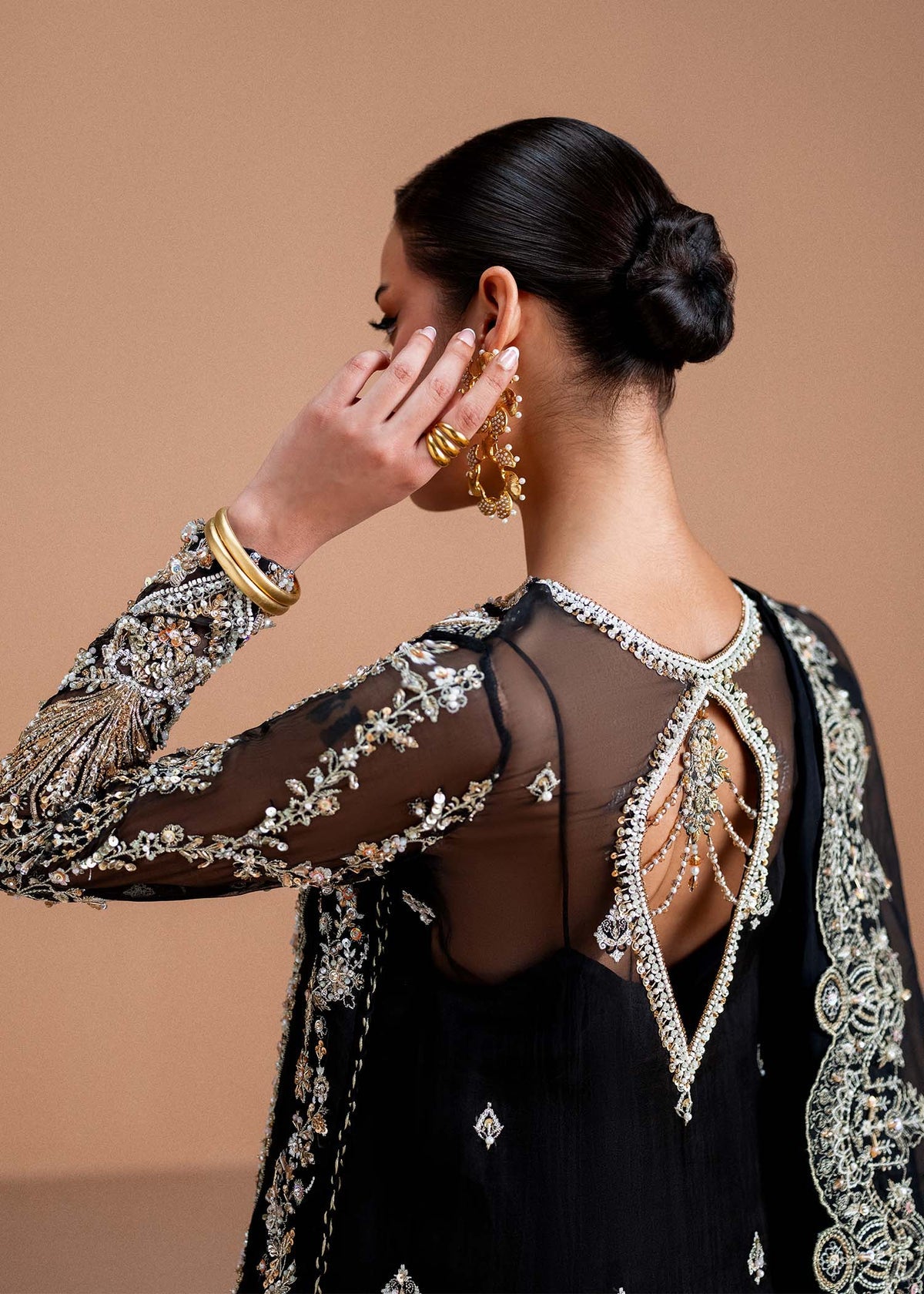 Model wearing black Rayen outfit from Kanwal Malik, showcasing intricate embroidery for Pakistani luxury pret and clothes online in UK.