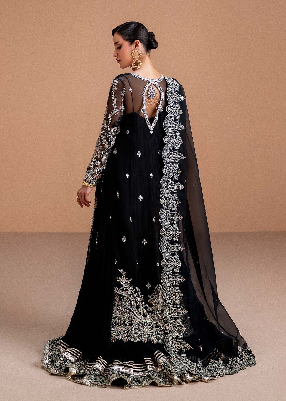 Model wearing black Rayen outfit from Kanwal Malik, showcasing intricate embroidery for Pakistani luxury pret and clothes online in UK.