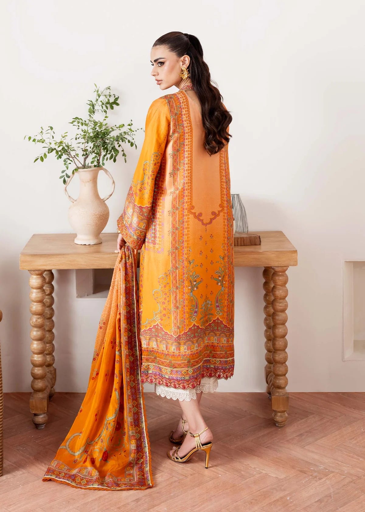 Model wearing orange Kira from Kanwal Malik Rosalia Silk Eid Collection '25, Pakistani luxury pret suit available online in UK.
