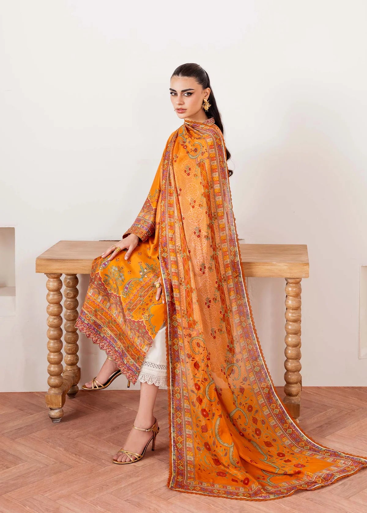 Model wearing orange Kira from Kanwal Malik Rosalia Silk Eid Collection '25, Pakistani luxury pret suit available online in UK.