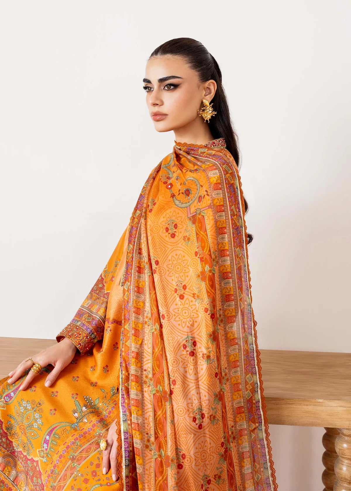 Model wearing orange Kira from Kanwal Malik Rosalia Silk Eid Collection '25, Pakistani luxury pret suit available online in UK.