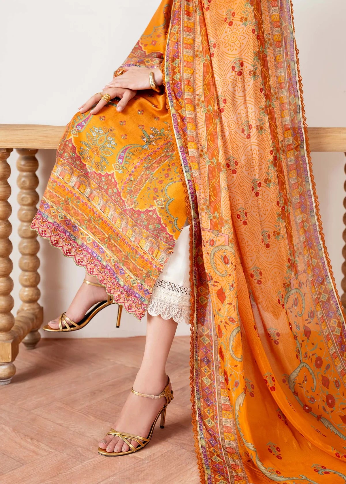 Model wearing orange Kira from Kanwal Malik Rosalia Silk Eid Collection '25, Pakistani luxury pret suit available online in UK.