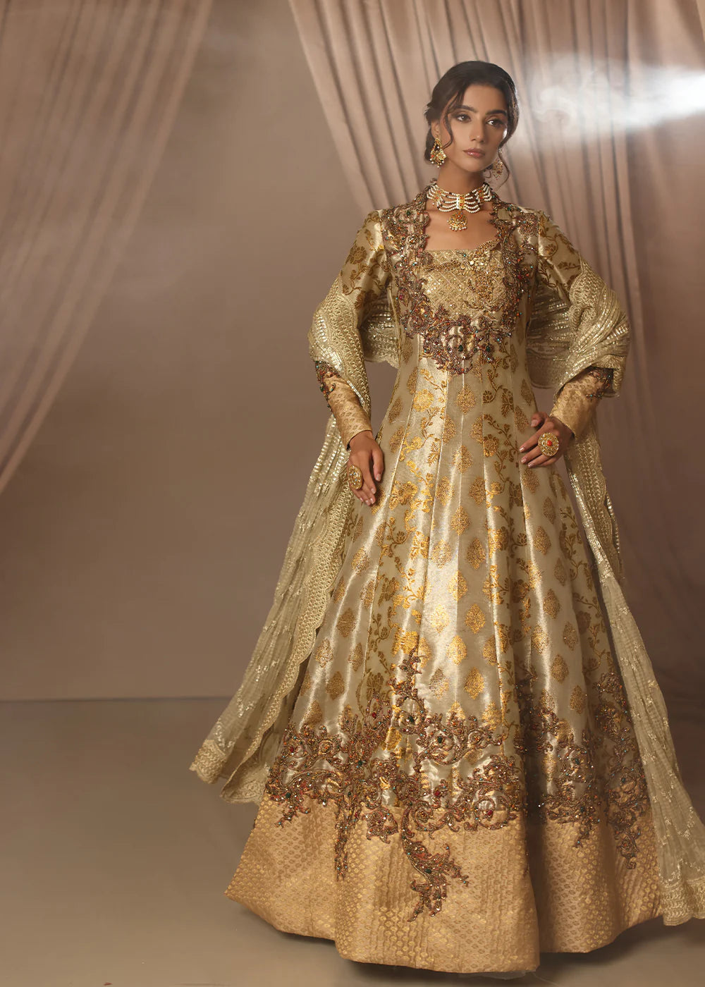 Model wearing gold heavily embroidered dress from Musferah Saad Eternal Grace, Pakistani luxury pret available online in UK.