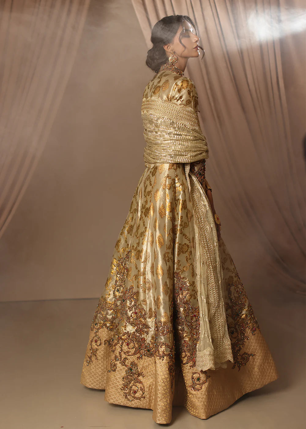 Model wearing gold heavily embroidered dress from Musferah Saad Eternal Grace, Pakistani luxury pret available online in UK.