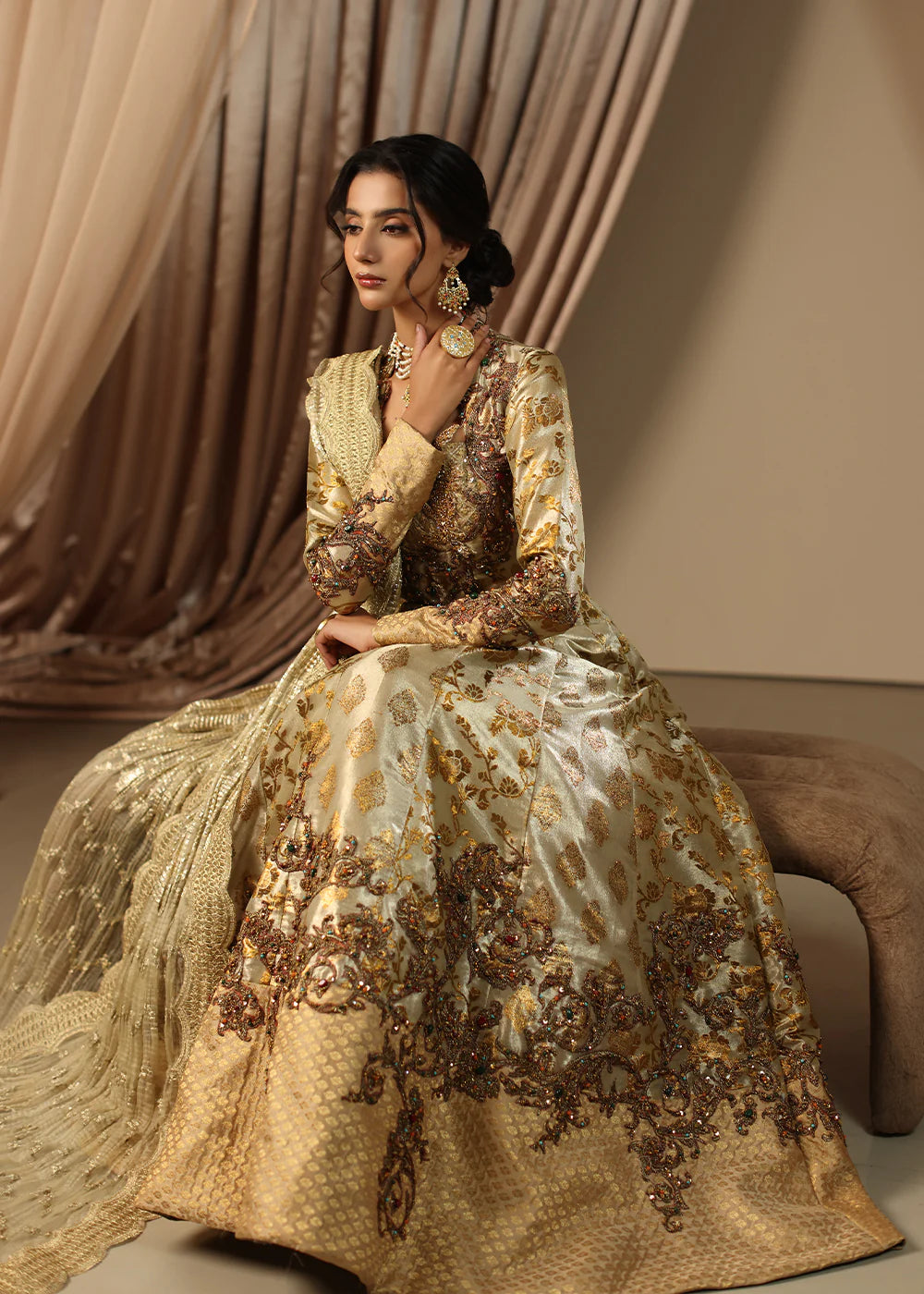 Model wearing gold heavily embroidered dress from Musferah Saad Eternal Grace, Pakistani luxury pret available online in UK.