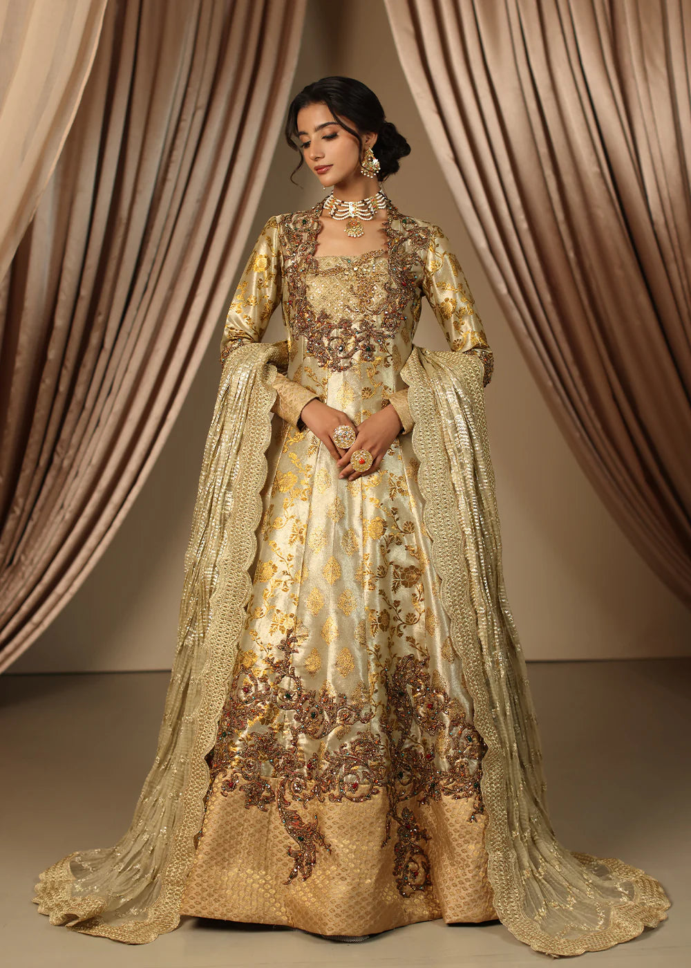 Model wearing gold heavily embroidered dress from Musferah Saad Eternal Grace, Pakistani luxury pret available online in UK.