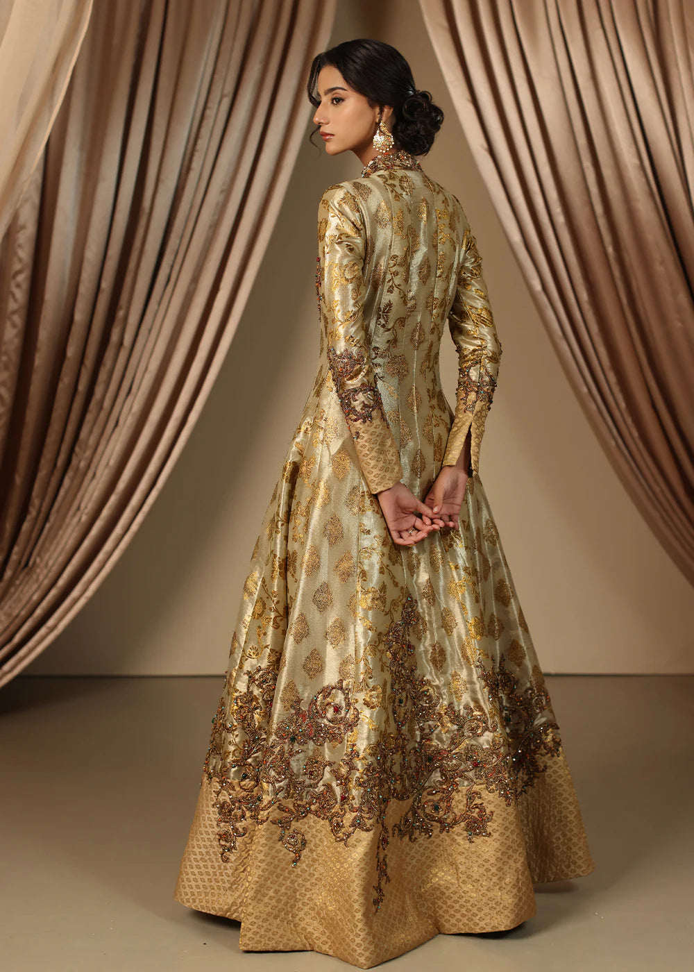 Model wearing gold heavily embroidered dress from Musferah Saad Eternal Grace, Pakistani luxury pret available online in UK.