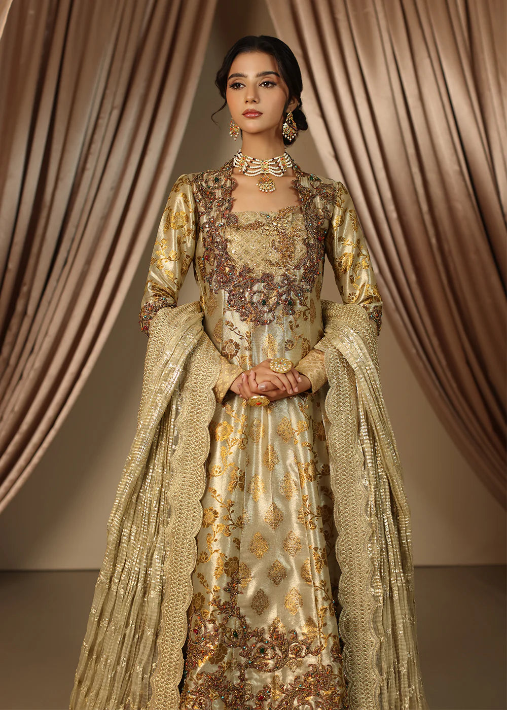 Model wearing gold heavily embroidered dress from Musferah Saad Eternal Grace, Pakistani luxury pret available online in UK.